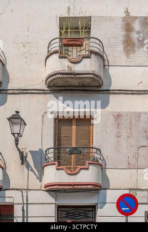 Art Deco Style Balconies on Vintage Building Facade, Curved Metal Railings, Shuttered Windows, Weathered White Wall, Traditional Architecture Stock Photo