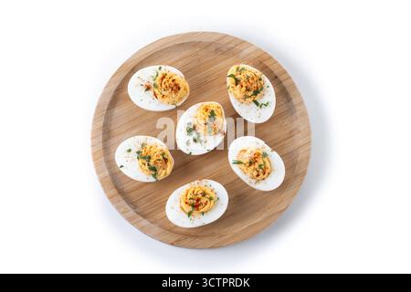 Homemade hard Boiled Deviled Eggs garnished with herbs isolated on white background Stock Photo