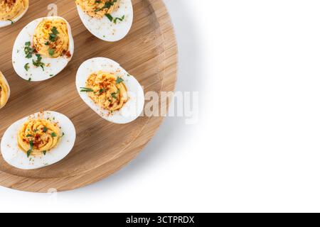 Homemade hard Boiled Deviled Eggs garnished with herbs isolated on white background Stock Photo