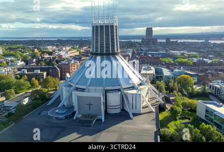 Liverpool Metropolitan catholic cathedral of Christ the King in Liverpool with the anglican cathedral of St.james and river Mersey in the background. Stock Photo