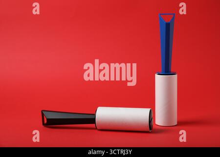 Two sticky lint rollers on red background Stock Photo