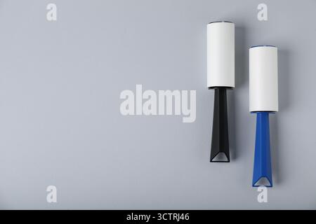 Two lint rollers on light grey background, flat lay. Space for text Stock Photo