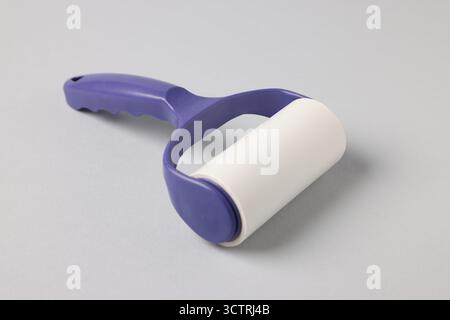 One lint roller on light grey background, closeup Stock Photo
