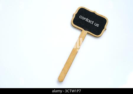 A small Contact  Us  note on blackboard on white background Stock Photo