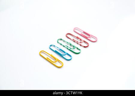 Coloured paper clips close-up on a white background Stock Photo