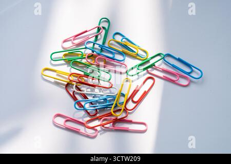 Coloured paper clips close-up on a white background Stock Photo