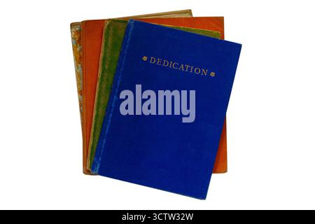 Selection of hardback books with old vintage Dedication book on top isolated on white background Stock Photo