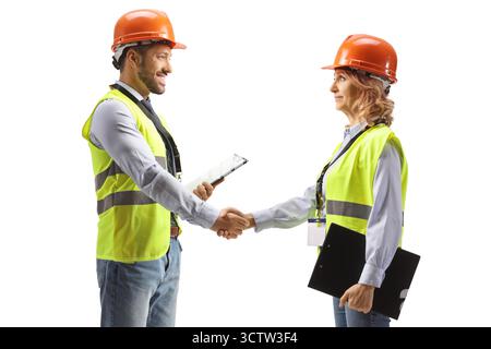 Profile shot of two engineers shaking hands isolated on white background Stock Photo
