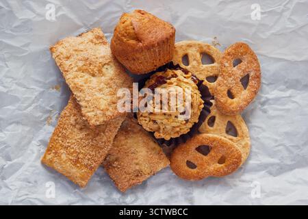 Various Cookies For Lunch. The Heap Of Sweets On Crumpled Paper Background, View From Above. Stock Photo