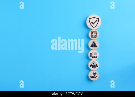 Work safety and compliance concept. Wooden blocks with safety, checklist, warning, training, and care icons representing workplace safety, compliance, Stock Photo