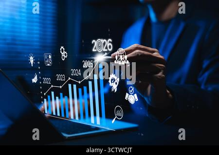 Businessman analyzing digital bar chart with rising trend from 2022 to 2026. Concept of business growth, success strategy, data analytics, Stock Photo