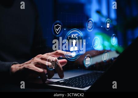 Businessman using laptop with digital KYC interface and identity verification icons. Concept of cybersecurity, online banking, secure authentication, Stock Photo