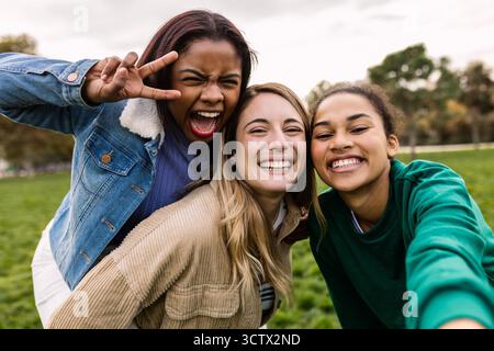Diverse female college student friends taking selfie Stock Photo