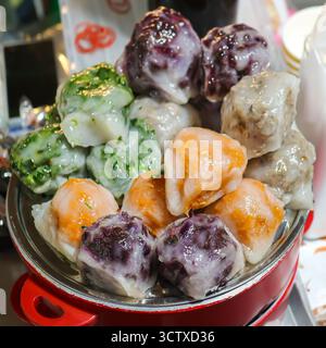 Colorful, round Thai Chive Cakes (Kuicheai) with assorted vegetable fillings. A delicious Asian vegetarian street food snack. Stock Photo