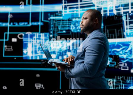 African american IT engineer works in AI ethics and neural networks, virtual intelligence brain tools for machine learning systems. Algorithmic thinking development on dashboard. Stock Photo