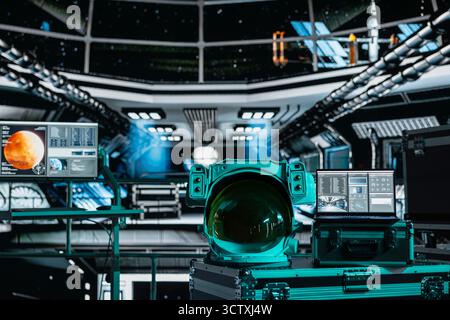 Close up of space helmet next to laptop monitor in spaceship displaying planetary scan of Mars. Notebook display in spacecraft showing red planet surface analytics data during flight Stock Photo