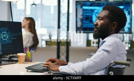 Computer scientist with paraplegia in office automating repetitive tasks with AI scripts. IT professional in wheelchair using artificial intelligence to speed up feature implementation, camera A Stock Photo