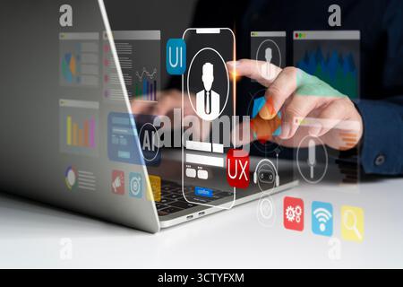Creative UI UX designer using laptop for digital interface development with AI technology, data visualization, and mobile app innovation, representing Stock Photo
