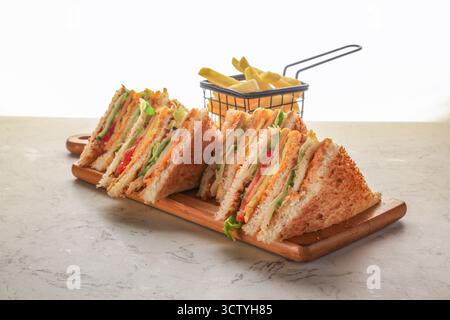 Classic Club Sandwich in White Bread, Grilled Chicken, Fried Egg, Tomato, Lettuce, Cucumber Sliced Cheddar Stock Photo