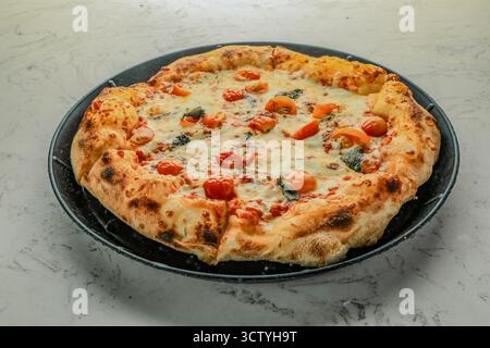 Pomodoro Tomato Sauce, Mozzarella, Basil, Sweet Cherry Tomatoes, Oregano, and Olive Oil Pizza Stock Photo