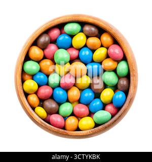 Colorful sugar-coated chocolate dragees, in a wooden bowl. Dragee chocolate confectionery. Stock Photo