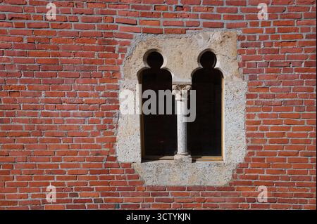 Stone window on the brick wall Stock Photo
