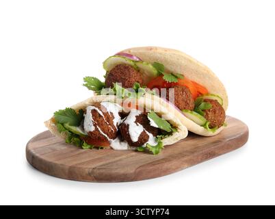 Wooden board of delicious pitas with falafel on white background Stock Photo
