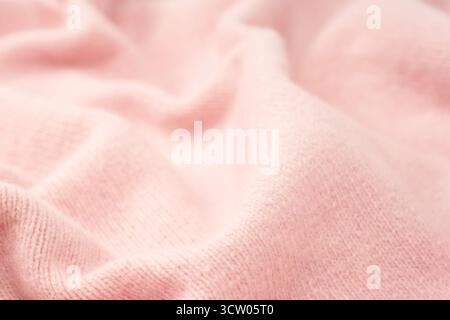 Soft pink cashmere sweater texture background. Top view. Stock Photo
