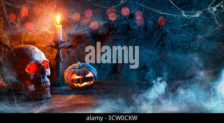 Skull And Pumpkin In Spooky Night - Candle And Fog In Horror Composition Stock Photo
