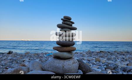 Zen-like Stack of Balanced Stones on a Pebble Beach in Antalya, Turkey Stock Photo