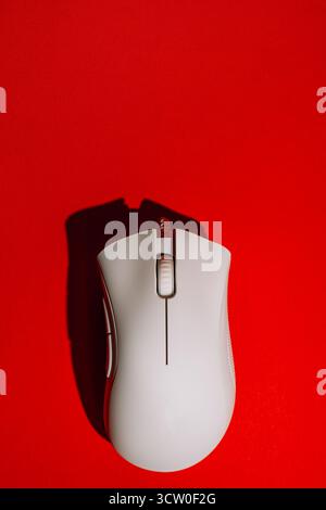 White wired gaming mouse on red background top view Stock Photo