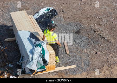 Espoo, Finland - September 12, 2025: A construction site on Meritie Street during the building of a new road, worker is preparing to make wooden found Stock Photo