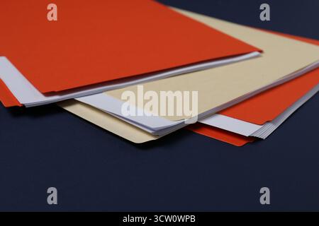 Many documents in folders on dark blue background, closeup Stock Photo