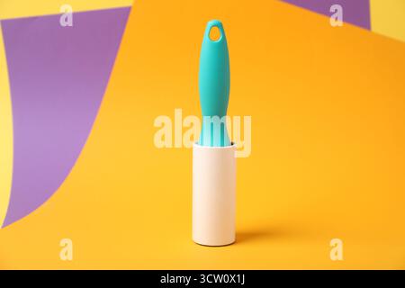 One sticky lint roller on color background Stock Photo