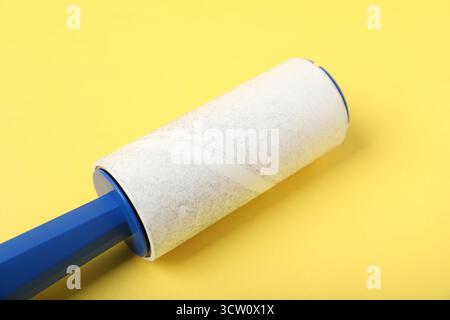 One lint roller on yellow background, closeup Stock Photo