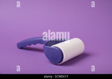 One lint roller on purple background, closeup Stock Photo