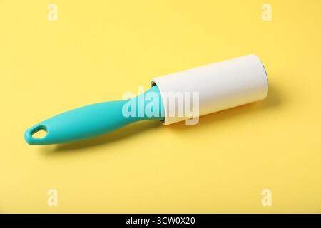One lint roller on yellow background, closeup Stock Photo
