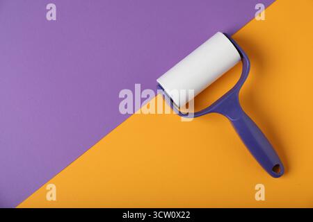 One lint roller on color background, top view. Space for text Stock Photo