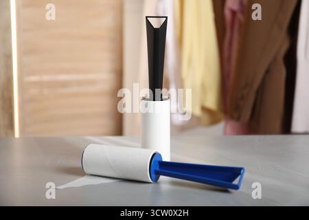 Lint rollers on grey table indoors, closeup Stock Photo