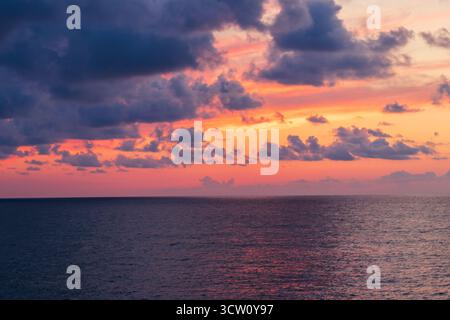 Shot of the dramatic sunset by the beach. Stock Photo