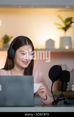 Podcasting. Young woman engaging in a lively discussion with a microphone setup. Stock Photo