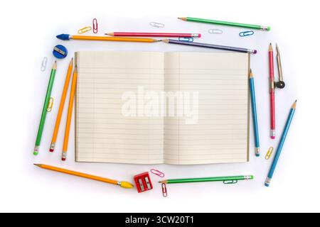 Back to School. School supplies ( copybook, pencils, sharpener, clips, compass ) on a white background with space for text. Top view, flat lay Stock Photo
