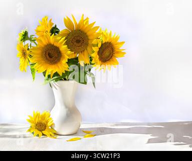 Bouquet of yellow flowers sunflower in porcelain vase on a white wooden table on light background with space for text Stock Photo