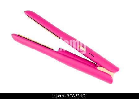 Cordless pink hair straightener, isolated on a white background. Stock Photo