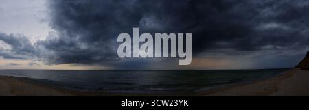 Storm dark clouds over sea water in summer Stock Photo