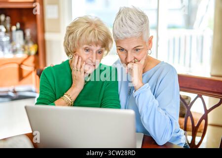 A daughter explaining some documentation to senior parent Stock Photo