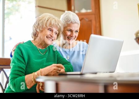 A daughter explaining some documentation to senior parent Stock Photo