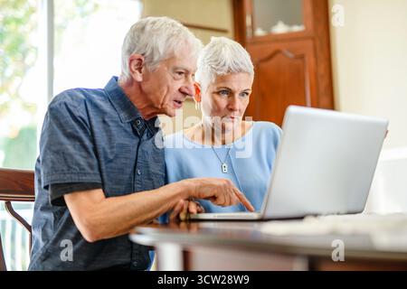 daughter explaining some documentation to senior parent Stock Photo