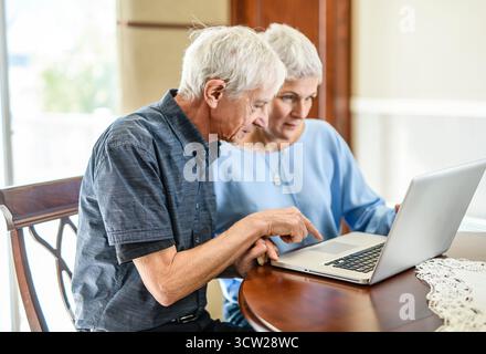 daughter explaining some documentation to senior parent Stock Photo