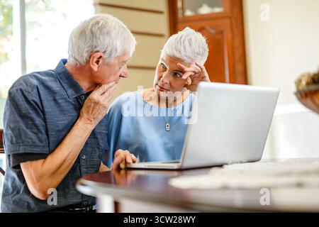 daughter explaining some documentation to senior parent Stock Photo